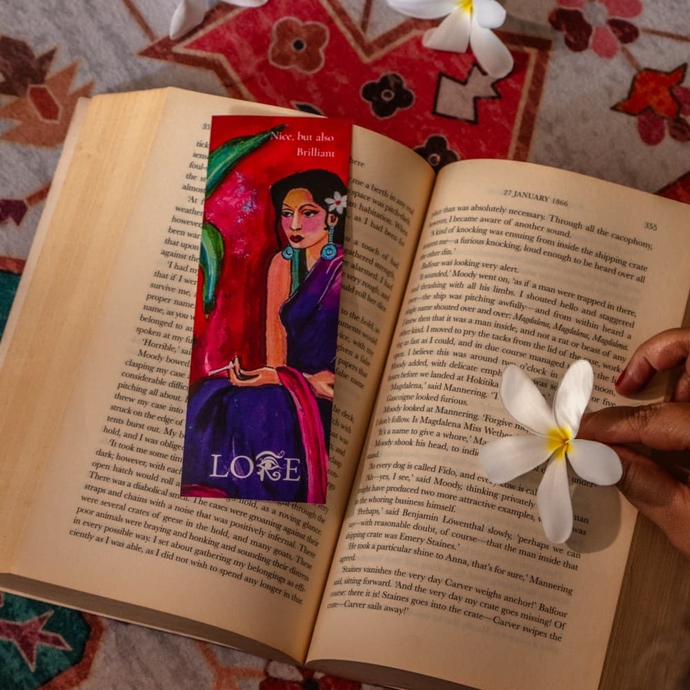 An illustrated bookmark styled on an open book with frangipani flowers
