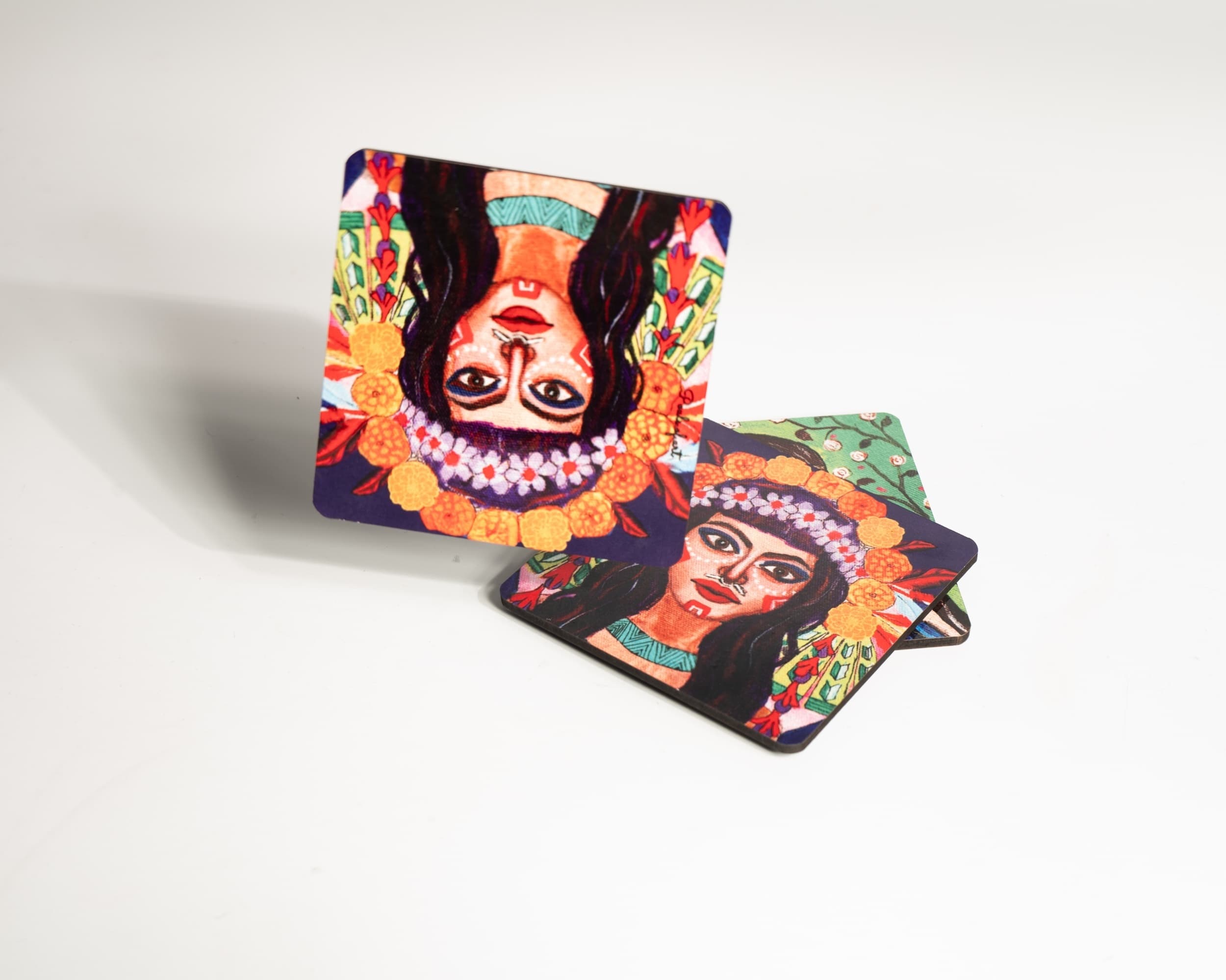 Two illustrated coasters styled upright against a plain background