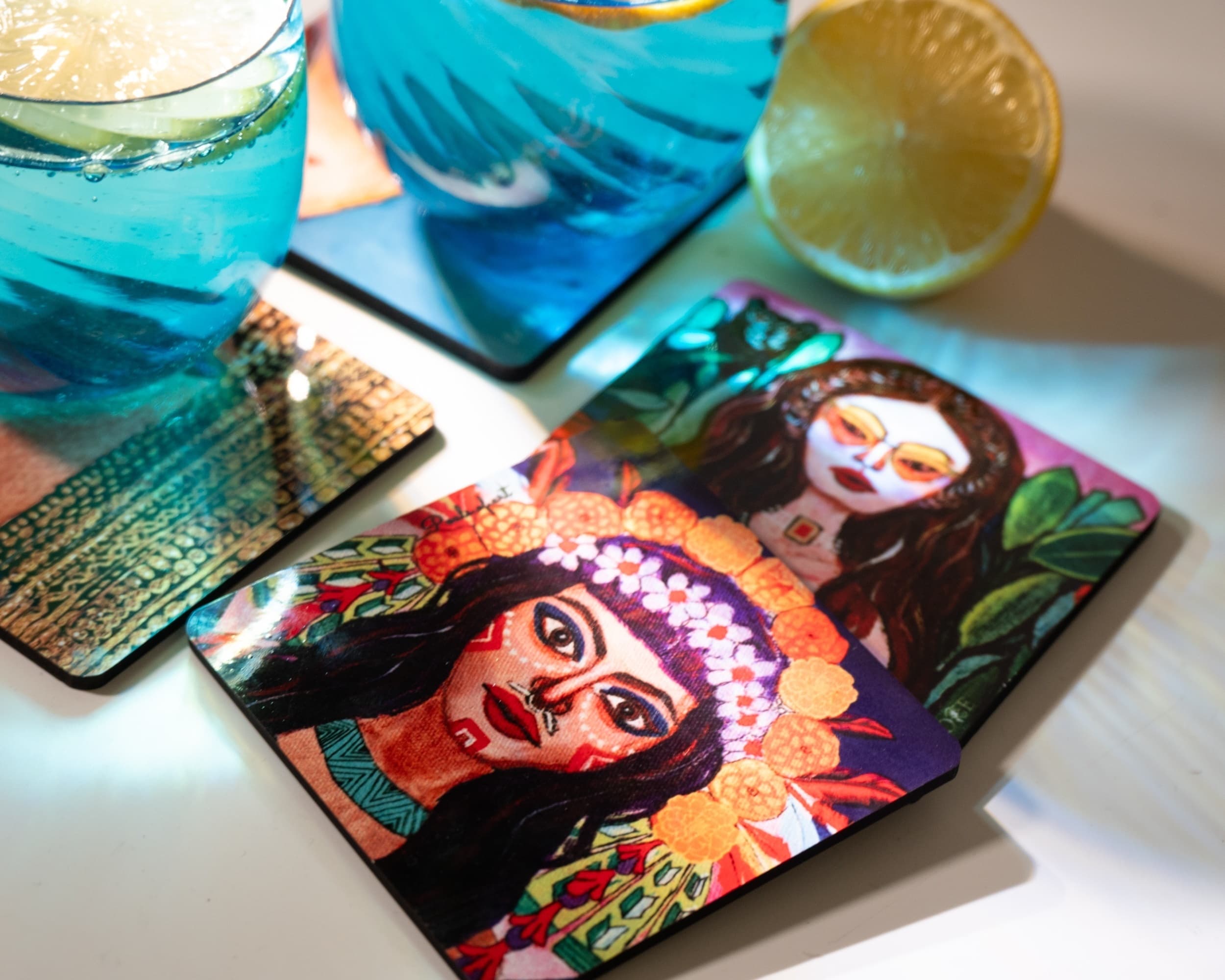 Illustrated coasters styled with iced drinks and citrus slices
